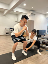 physiotherapist teaching rehab exercise to patient